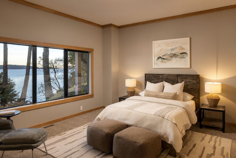Bedroom at BrightWoods with large windows toward the water