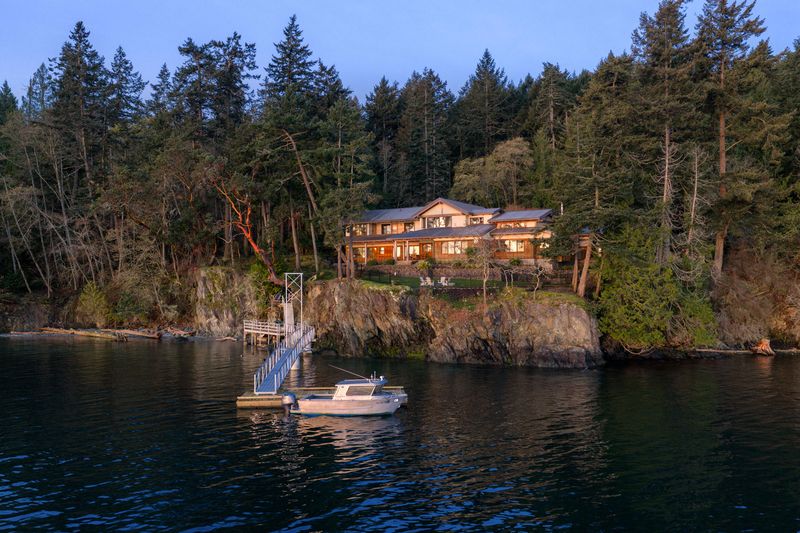 BrightWoods from Fulford Harbour at dusk, with the forest, residence and deep-water dock