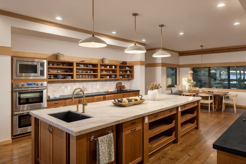Renovated kitchen at BrightWoods with extra-large island, double wall oven and Shaker cabinetry